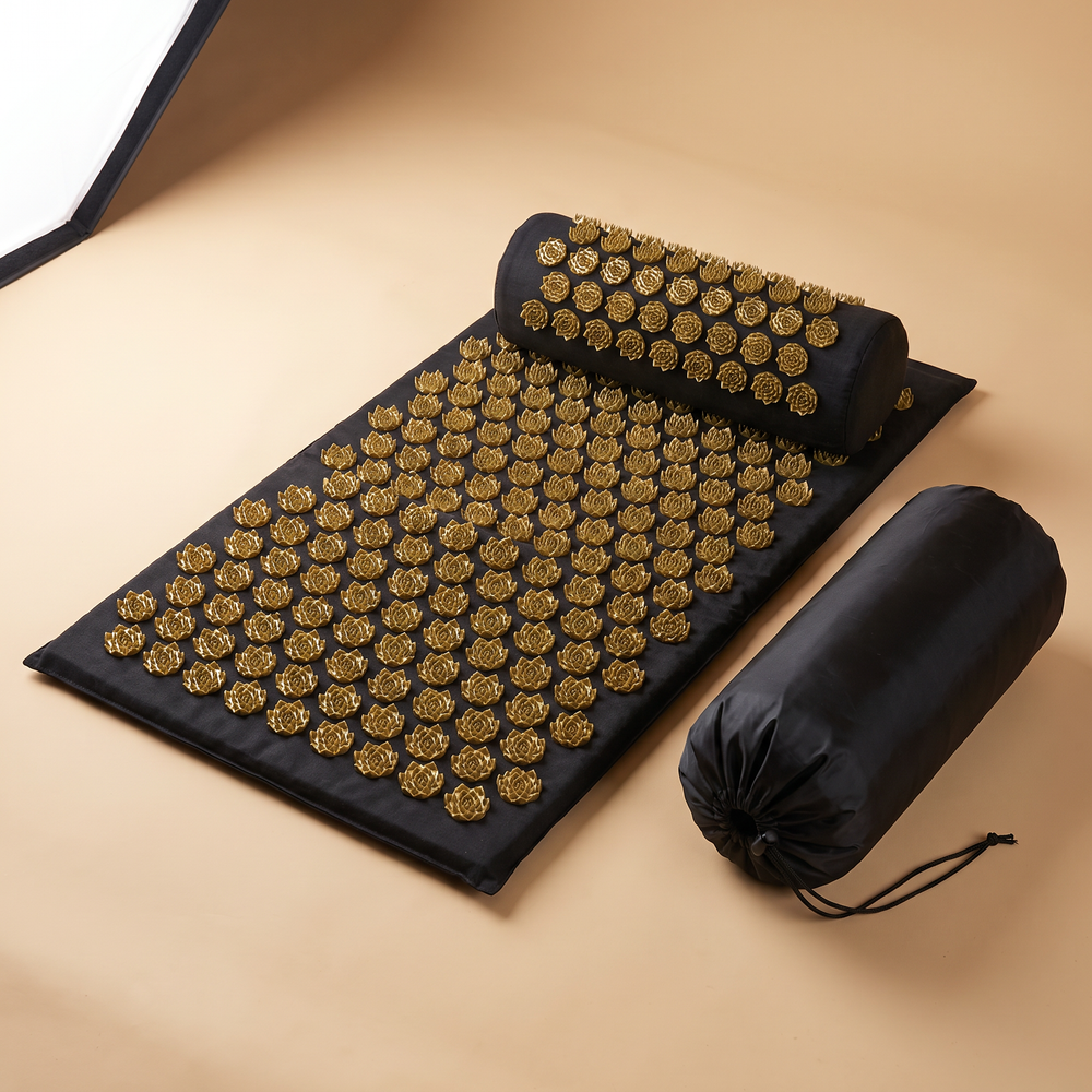 Premium acupressure mat set with black mat, gold lotus spikes, bolster pillow and storage bag
